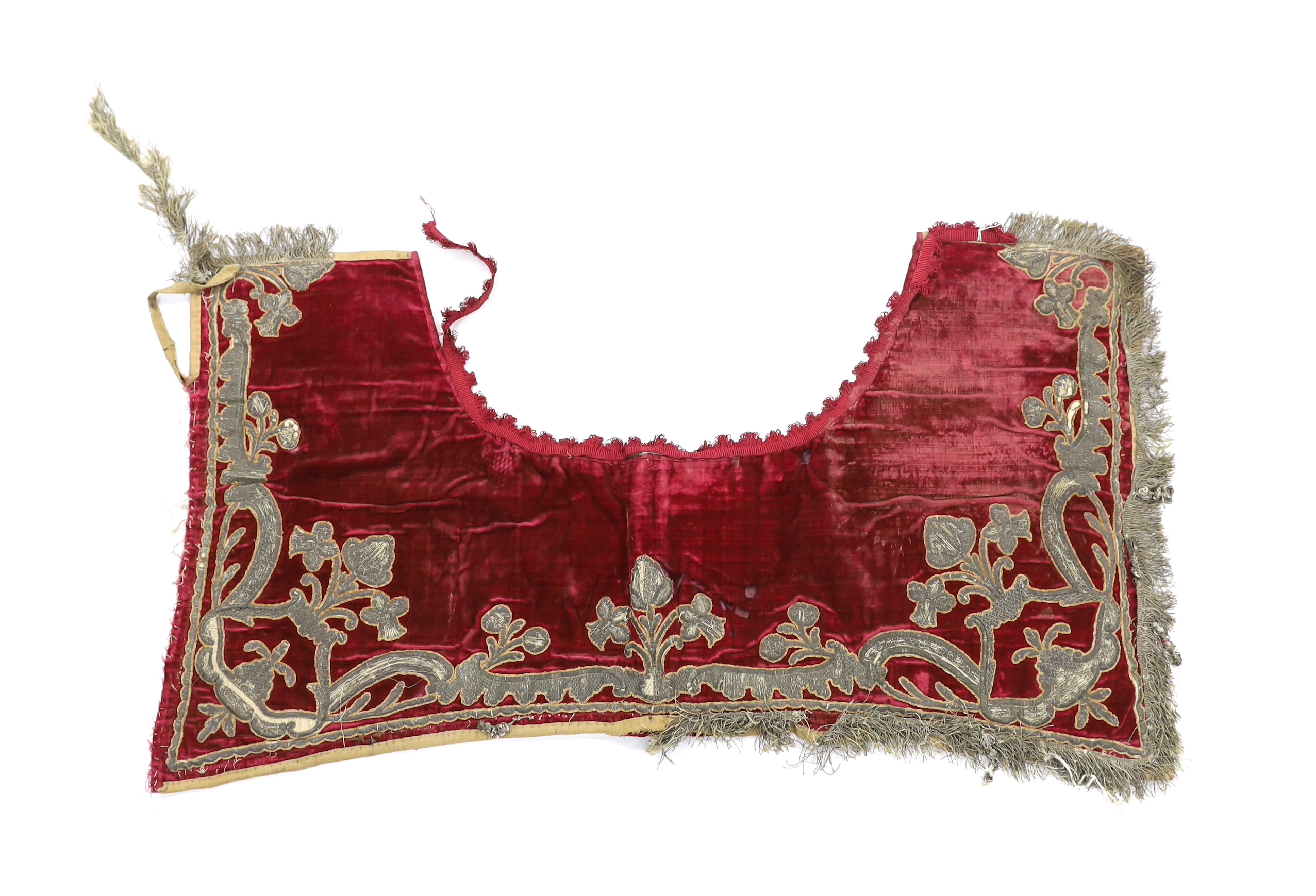 A burgundy velvet and silver thread embroidered and fringed saddle blanket, possibly Italian or Spanish, circa late 18th century, 94cm long x 50cm deep